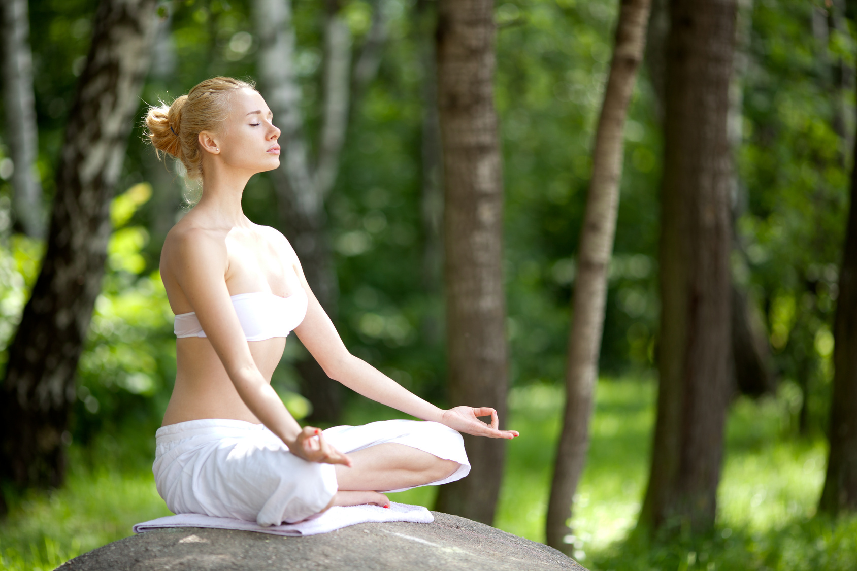 Young girl doing yoga in the park